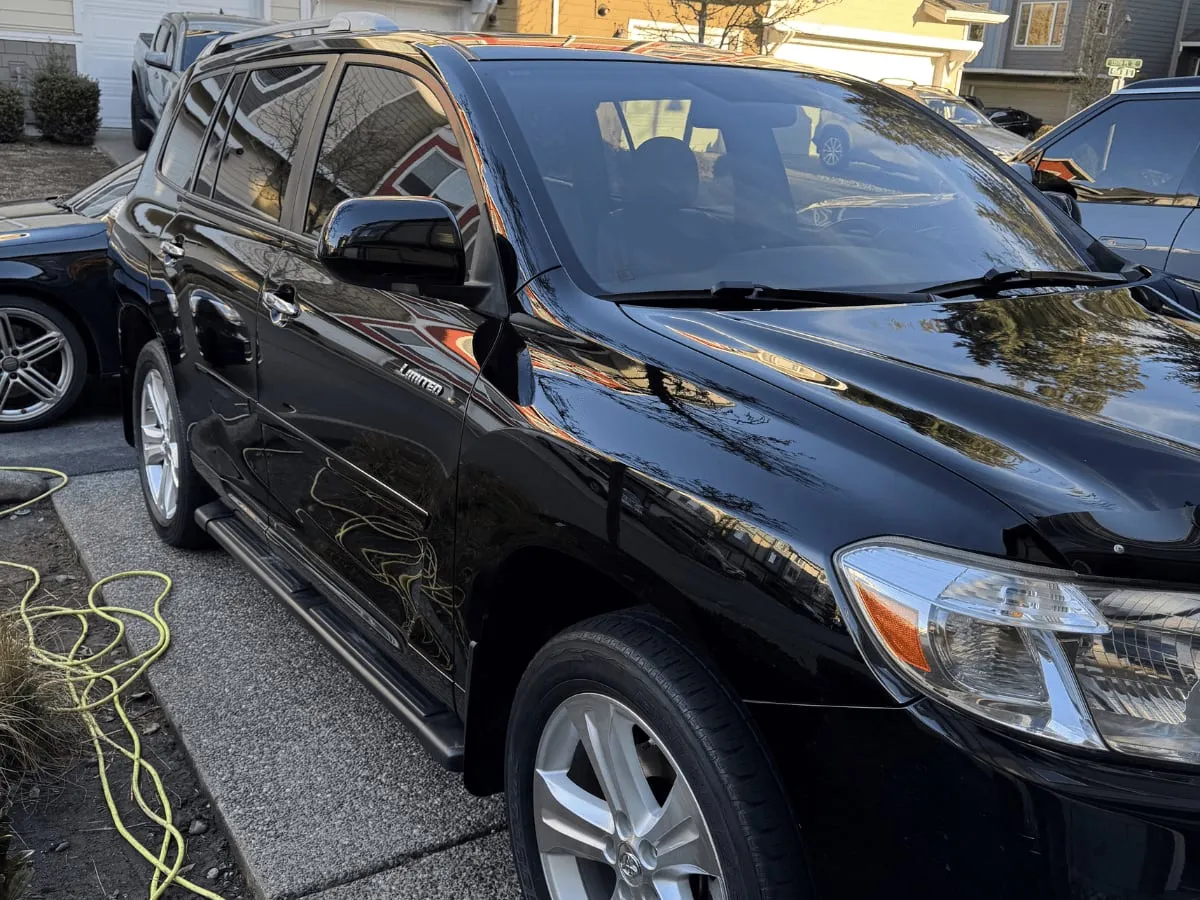 Side of a black SUV with a deep gloss finish