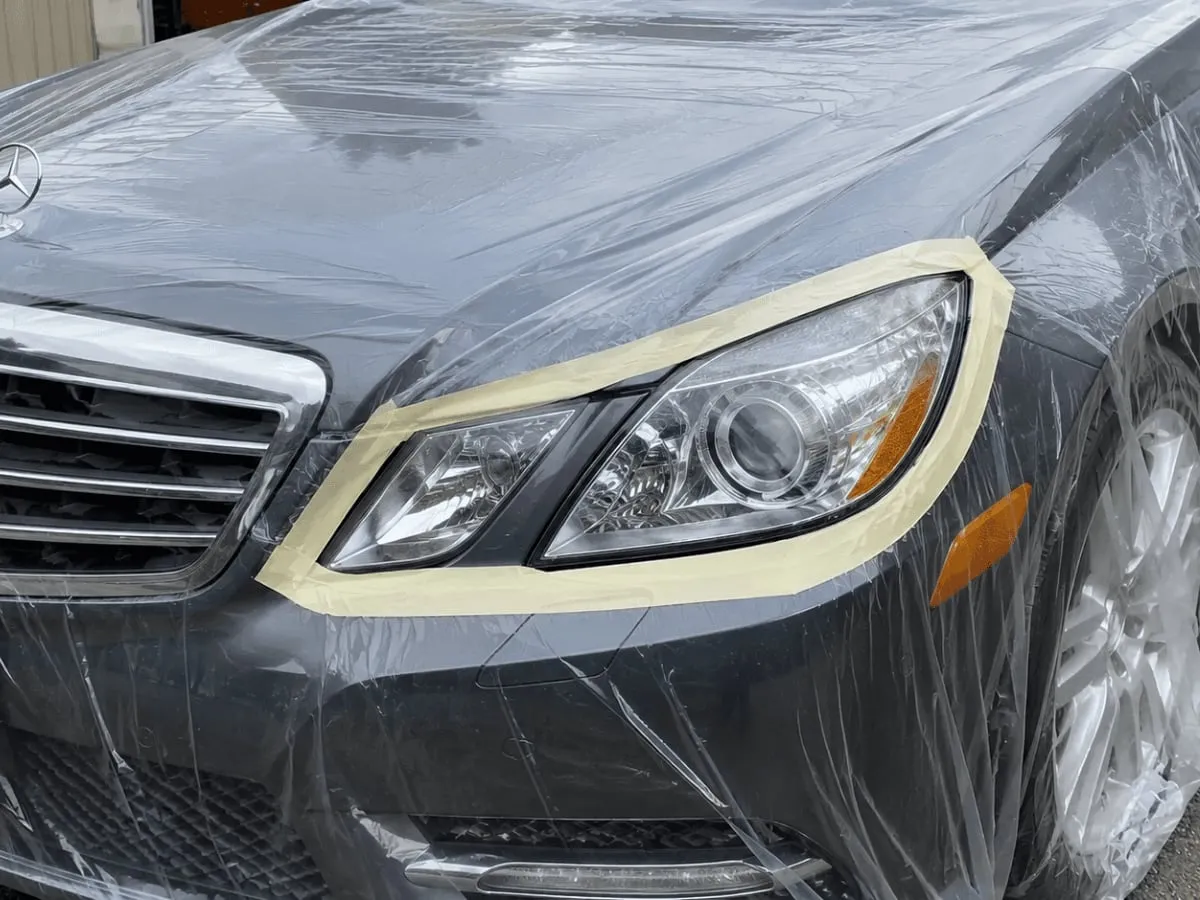 Mercedes headlight masked off before headlight restoration