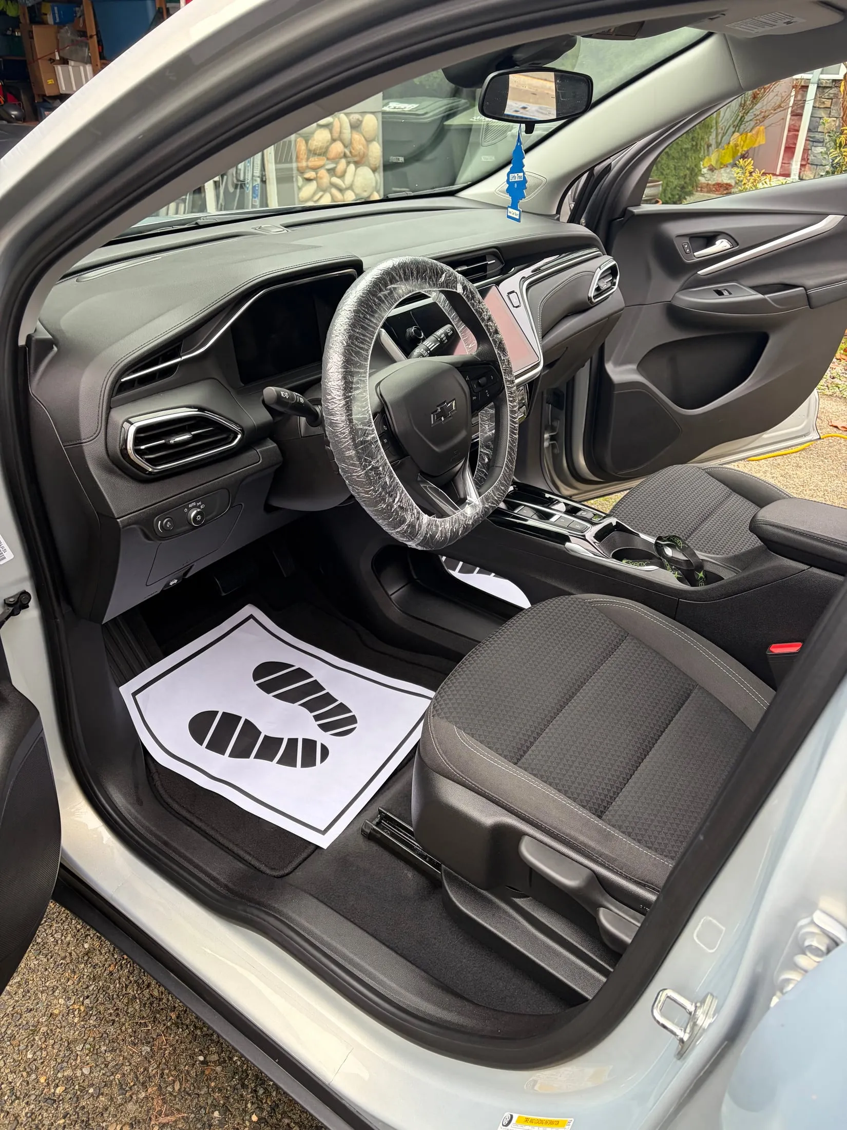 Driver side of a detailed interior with protective mats in place