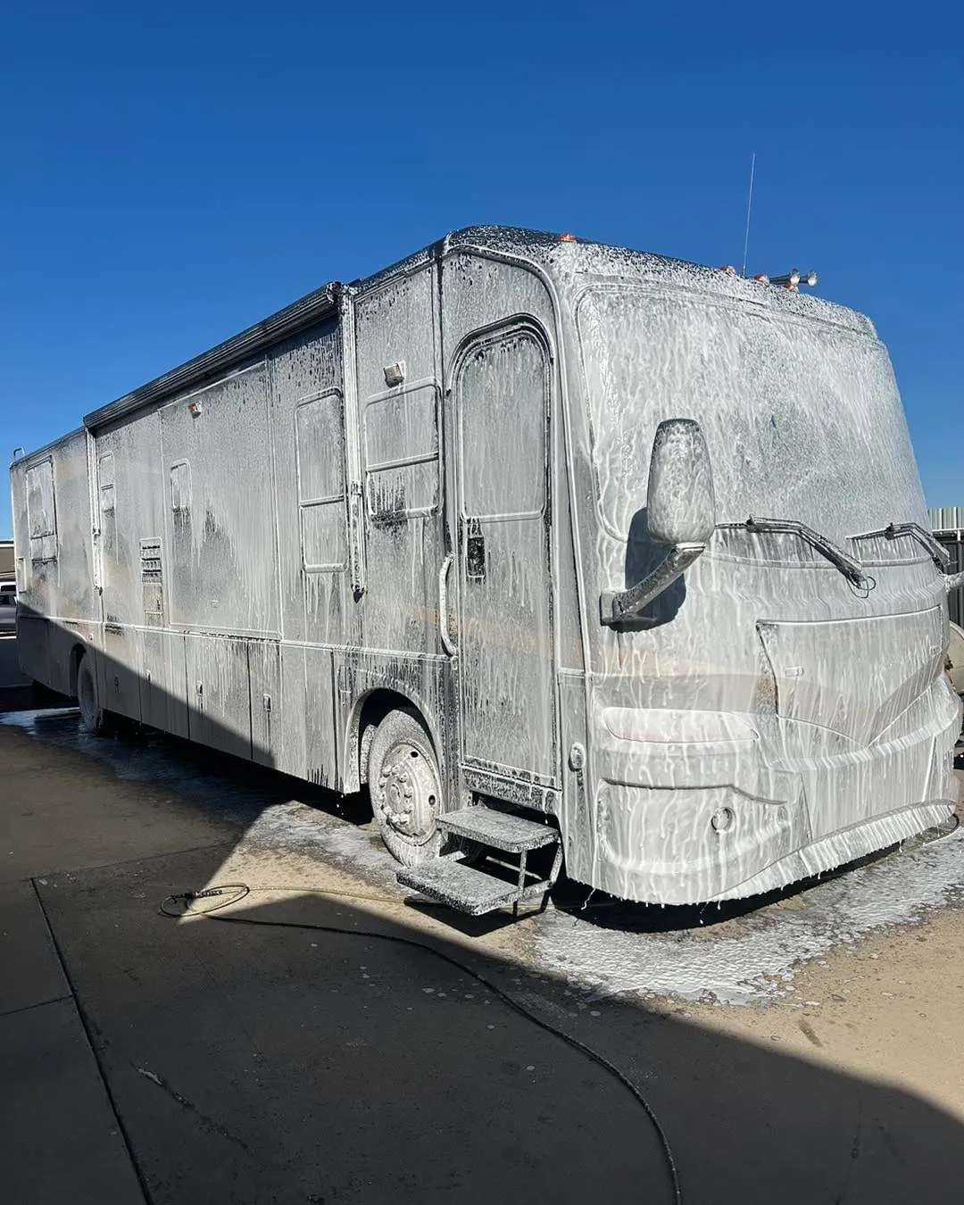 Motorhome covered in foam during a mobile RV wash