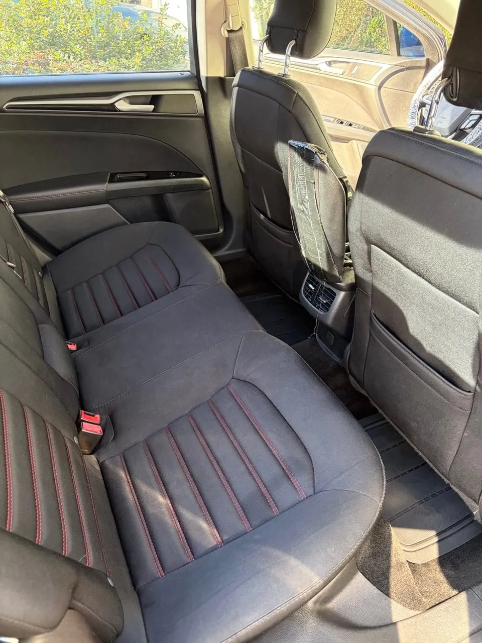 Rear seats with red stitching after an interior detail