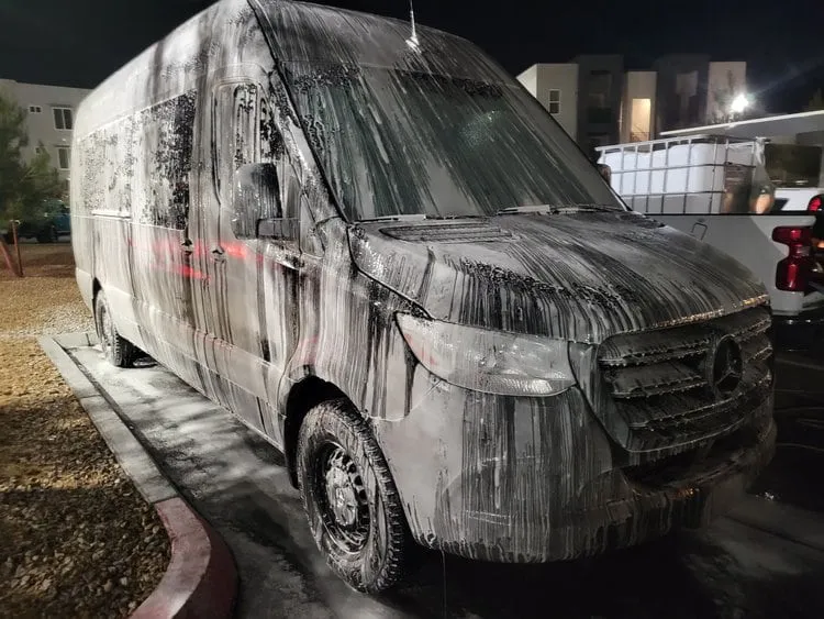 Mercedes Sprinter van covered in foam at night