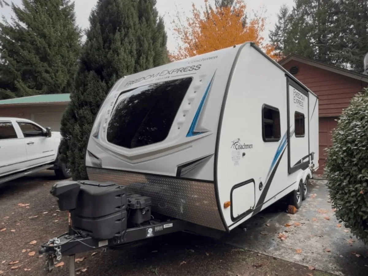 Side of a Coachmen travel trailer after washing